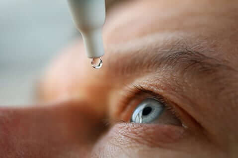 Person putting in eye drops